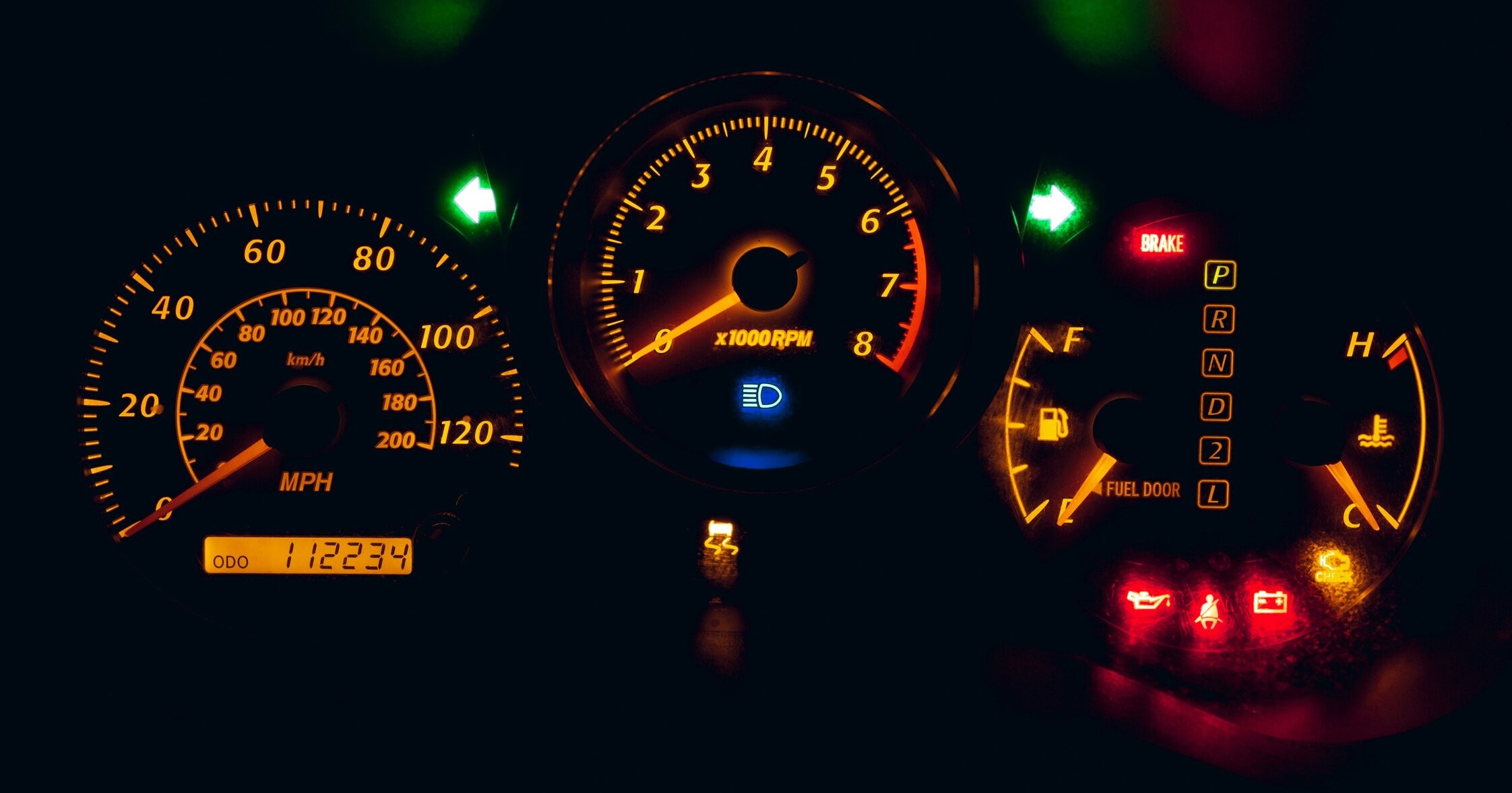 a close up of a car dashboard with warning lights